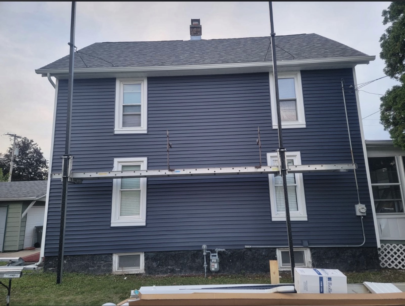 Two-story home with new navy blue siding